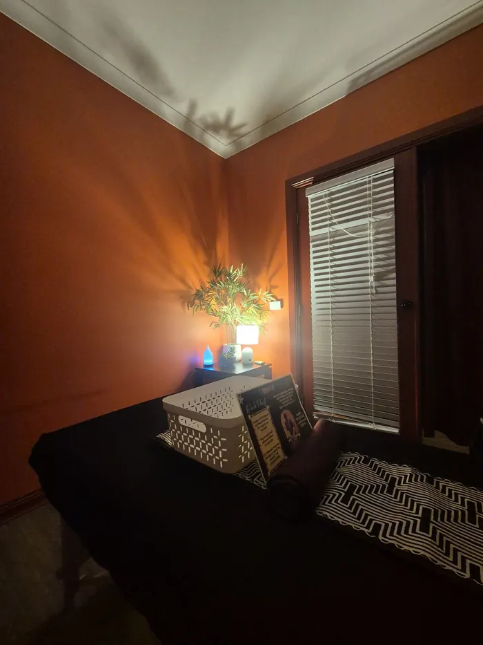 A dim treatment room lit by a single warm lamp